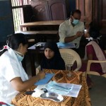 The Team of Doctors attending to the Students at the Dental screening camp